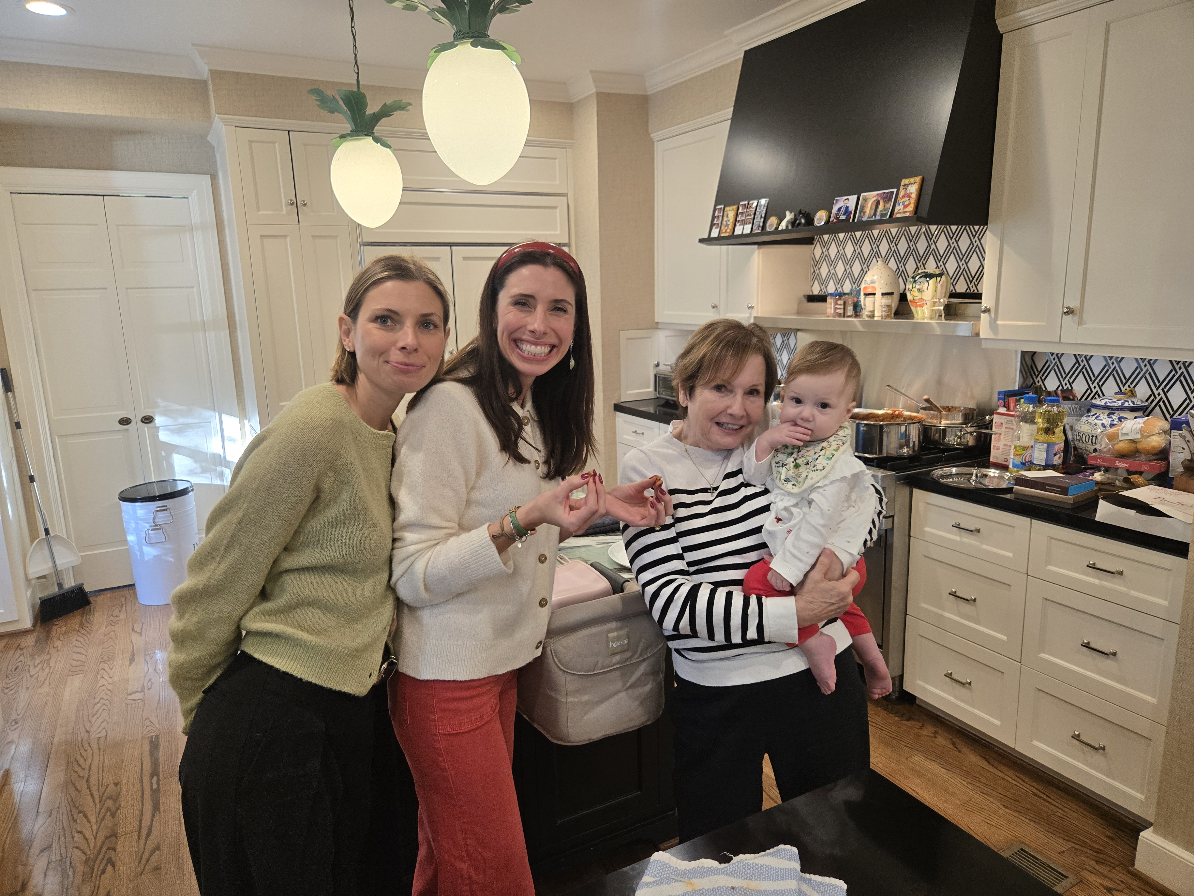 Four generations of family gathered together in the kitchen